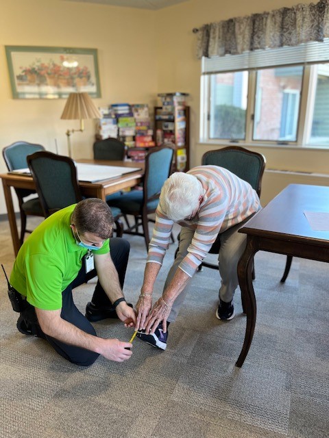 Donna Allen measuring Donnas reach to her toes